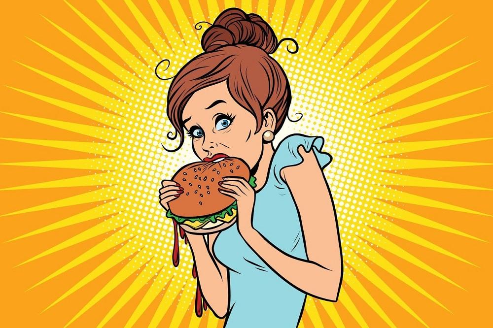 Mršava devojka jede burger